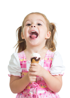 happy kid girl eating ice cream in studio isolated